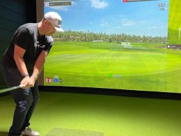Indoor Golf Range - Golfers practicing their swings in an indoor facility