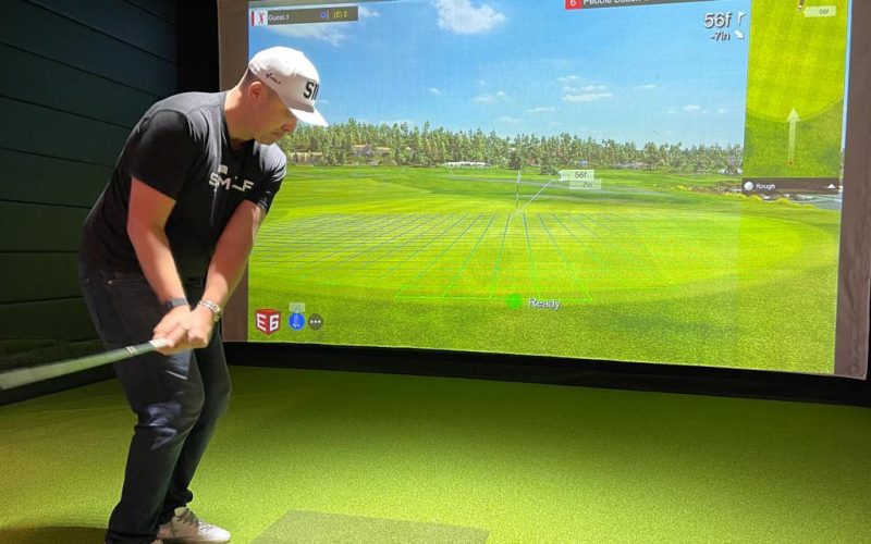 Indoor Golf Range - Golfers practicing their swings in an indoor facility