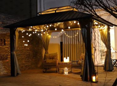 A serene Night Cloaked Deck under a starry sky with comfortable seating, soft lighting, and lush greenery.